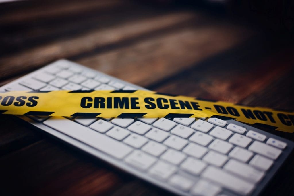 Crime scene tape over a computer keyboard for pornography