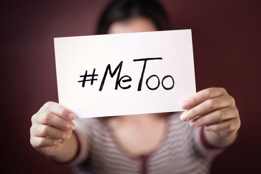 A woman holds a #metoo sign