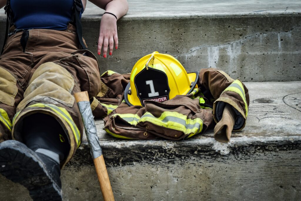 A firefighter lays his equipment down