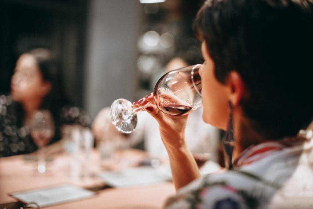 A woman drinks wine before an OWI