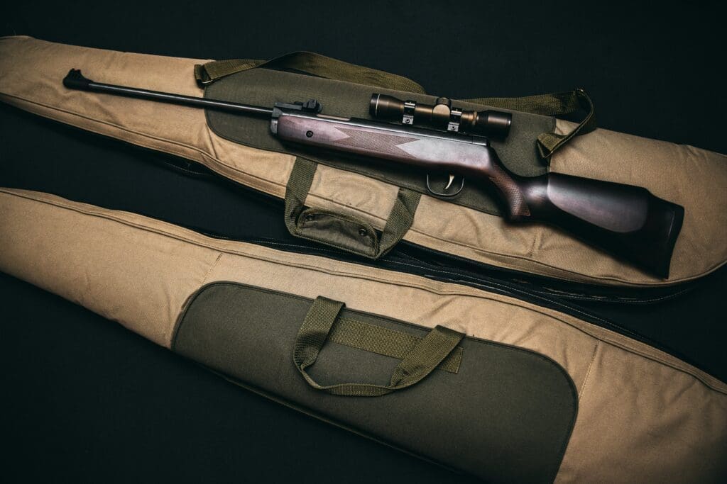 A rifle used for deer hunting appears in an unzipped gun bag