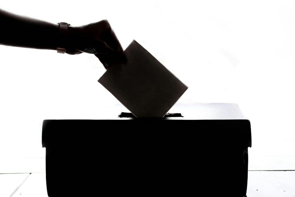 A person casts a ballot in an election.