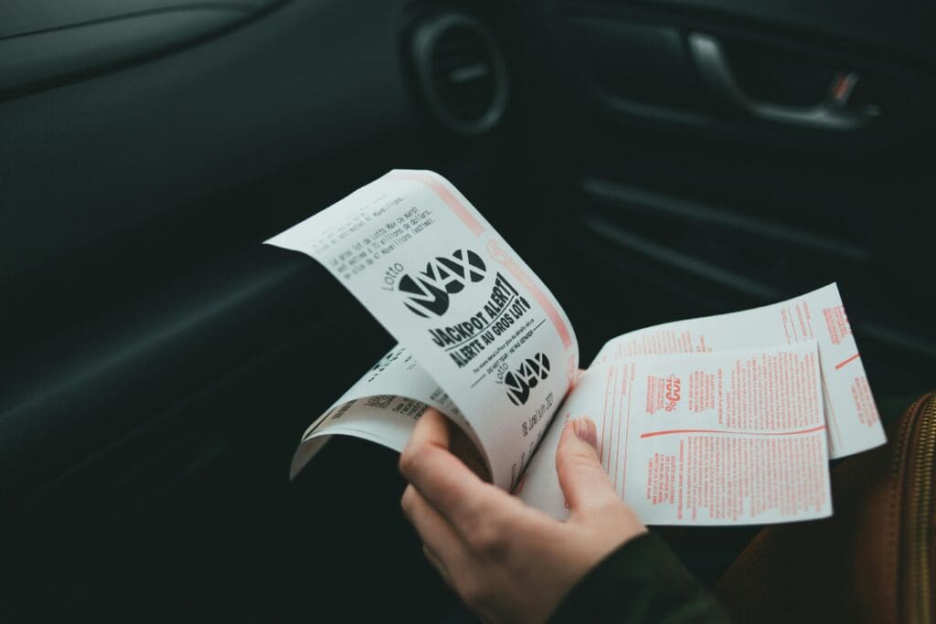 An individual looks at their lottery tickets