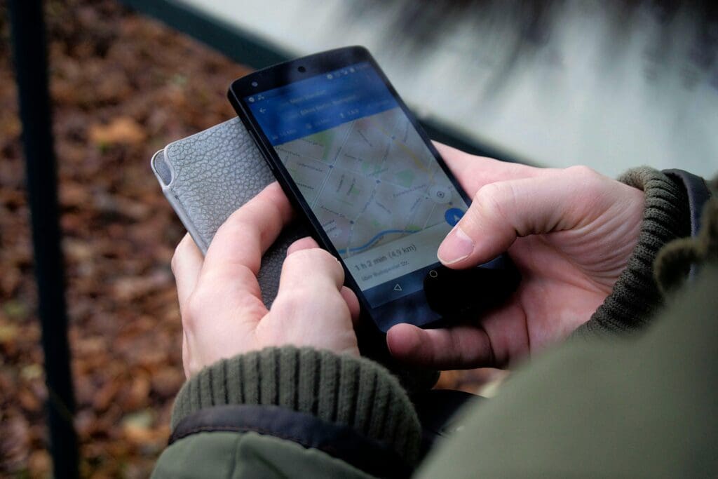 A man looks at his GPS-capable cell phone.