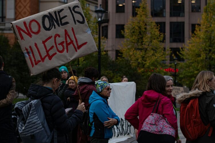 Individuals protest the Trump administration's immigration policies.
