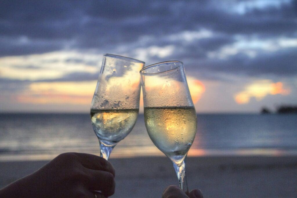 Two people on a date clink their champagne glasses