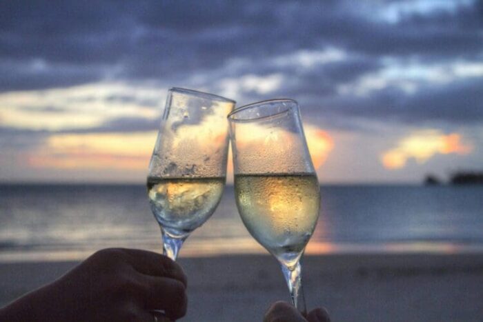 Two people on a date clink their champagne glasses