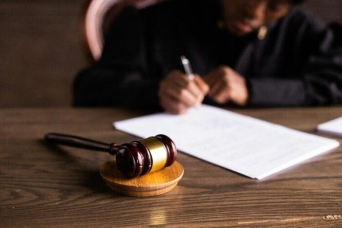 A judge signs a document.