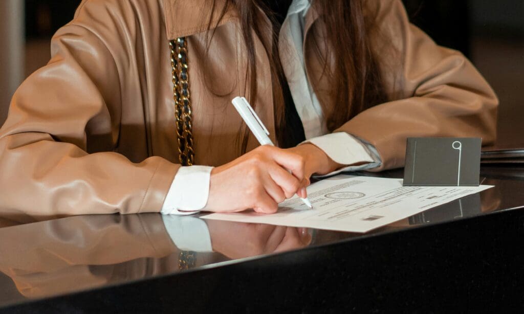 A woman signs a sworn statement